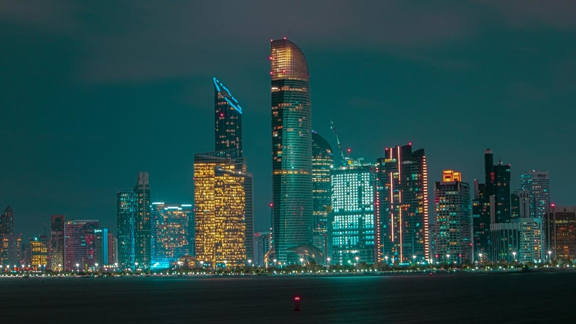File photo shows the Abu Dhabi skyline at night, June 22, 2021. (Unsplash)