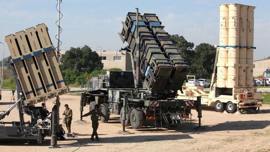 Israeli soldiers walk near an Israeli Irone Dome defence system (L), a surface-to-air missile (SAM) system, the MIM-104 Patriot (C), and an anti-ballistic missile the Arrow 3 (R) during Juniper Cobra's joint exercise press briefing at Hatzor Israeli Air Force Base in central Israel, on February 25, 2016. Juniper Cobra, is held every two years where Israel and the United States train their militaries together to prepare against possible ballistic missile attacks, as well as allowing the armies to learn to better work together. (Photo by GIL COHEN-MAGEN / AFP)