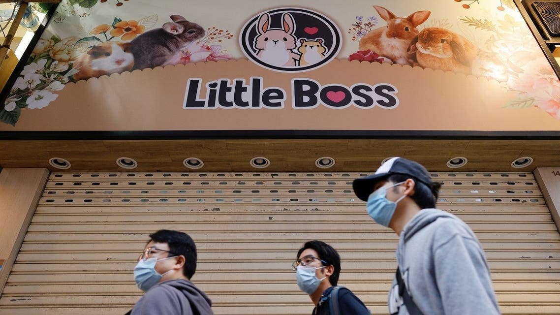 People stand in front of a temporarily closed pet shop after the government announced to euthanize around 2,000 hamsters in the city after finding evidence for the first time of possible animal-to-human transmission of COVID-19 in Hong Kong, China, January 18, 2022. (Reuters)