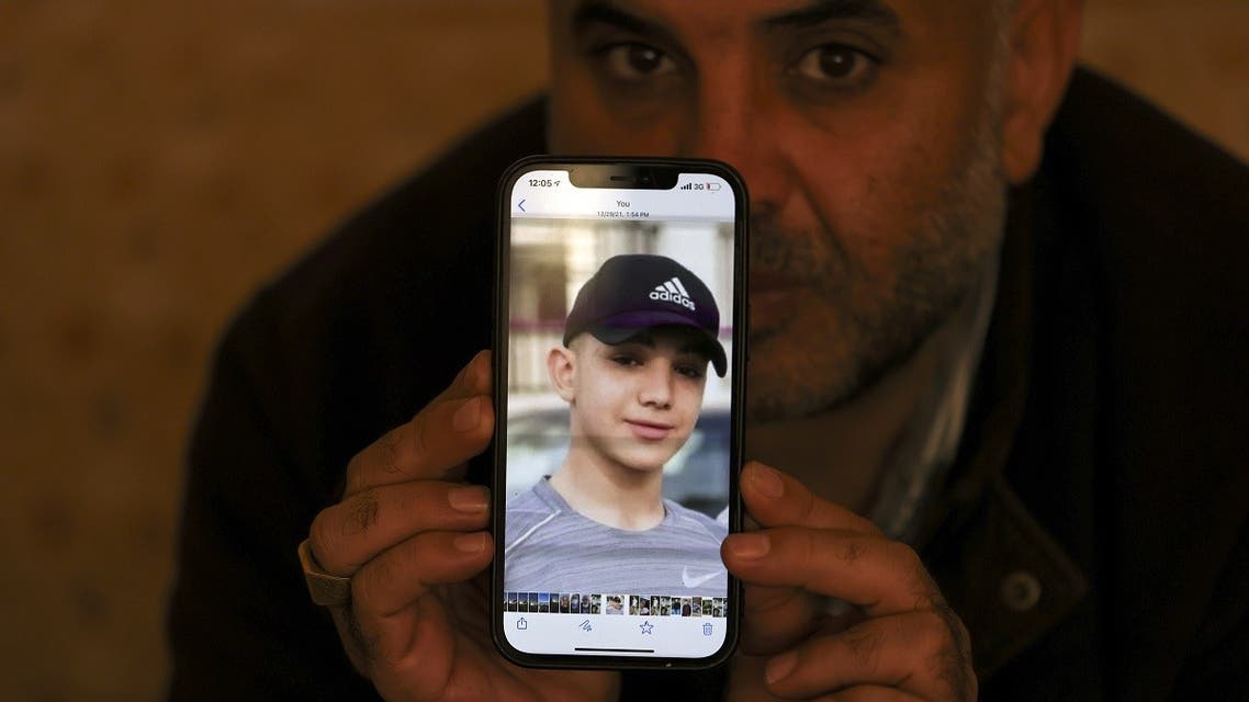  Moammar Nakhleh, the father of 17 year-old Palestinian prisoner Amal, shows a photograph of his son on his telephone, in Jalazun refugee camp, near the occupied West Bank city of Ramallah, on January 8, 2022. (AFP)