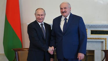 Russia's President Vladimir Putin (L) shakes hands with his Belarus’ counterpart Alexander Lukashenko in Saint Petersburg on July 13, 2021. (AFP)