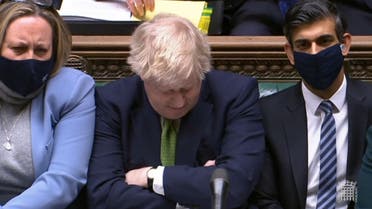 A video grab from footage broadcast by the UK Parliament's Parliamentary Recording Unit (PRU) shows British Prime Minister Boris Johnson reacting as Britain's main opposition Labour Party leader Keir Starmer (unseen) speaks during Prime Minister's Questions (PMQs), in the House of Commons in London on January 19, 2022. (AFP)