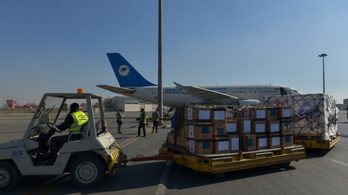 Workers prepare to transport a shipment of covid-19 coronavirus vaccine donated by the Chinese government at the Kabul airport in Kabul on December 8, 2021. (AFP)