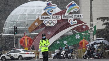 A policeman stands by an installation for the Beijing 2022 Winter Olympic and Paralympic Games on, Jan. 20, 2022. (AFP)