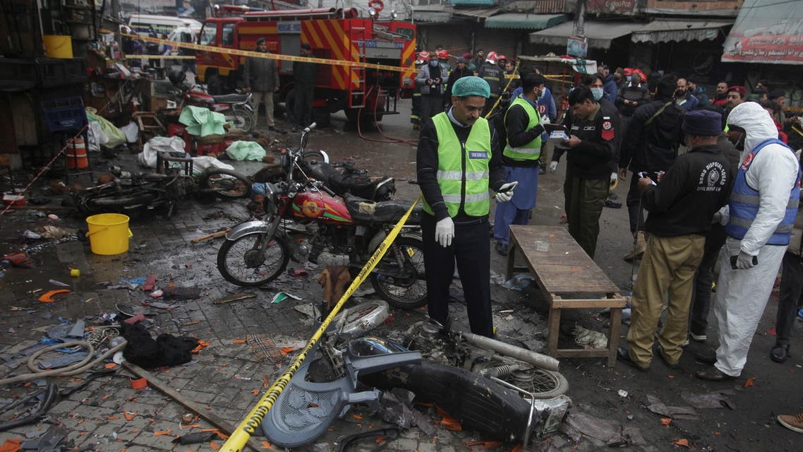 Members of crime scene unit and a bomb disposal team gather after a blast in a market, in Lahore, Pakistan January 20, 2022. (Reuters)
