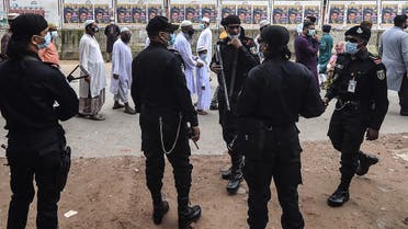 Rapid Action Battalion (RAB) members stand guard as people come to offer prayers to mark the start of the Muslim festival Eid al-Adha or the ‘Festival of Sacrifice, in Dhaka on July 21, 2021. (AFP)