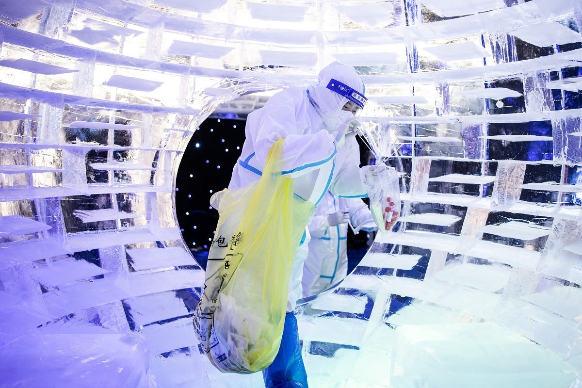 This photo taken on December 21, 2021 shows a health worker collecting samples to be tested for the COVID-19 coronavirus at an ice and snow themed park in Wuhan in China’s central Hubei province. (AFP)