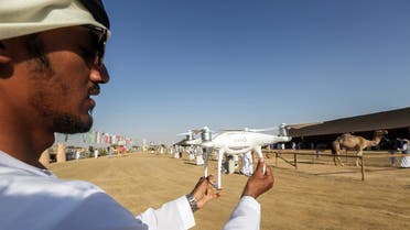An Emirati holds up a camera-equipped drone at the Suwahan heritage festival in Al-Ain on the outskirts of the Emirati capital Abu Dhabi, on February 8, 2017. (AFP)