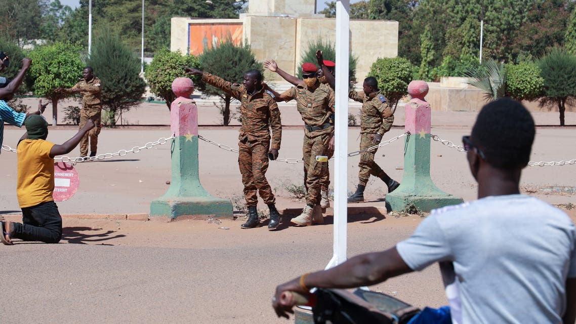 Army soldiers ask people to walk away as they gather outside Guillaume Ouedraogo army camp to show their support for the military after Burkina Faso President Roch Kabore was detained at a military camp in Ouagadougou, Burkina Faso January 24, 2022. (Reuters)