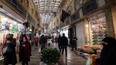 Mask-clad Iranians shop at the Tajrish Bazaar market in the capital Tehran, on January 16, 2022, during the coronavirus pandemic. (AFP)