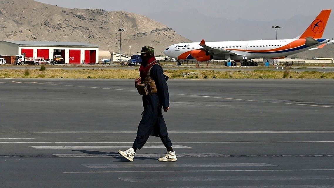 A Taliban fighter walks at the airport in Kabul on October 26, 2021. (AFP)