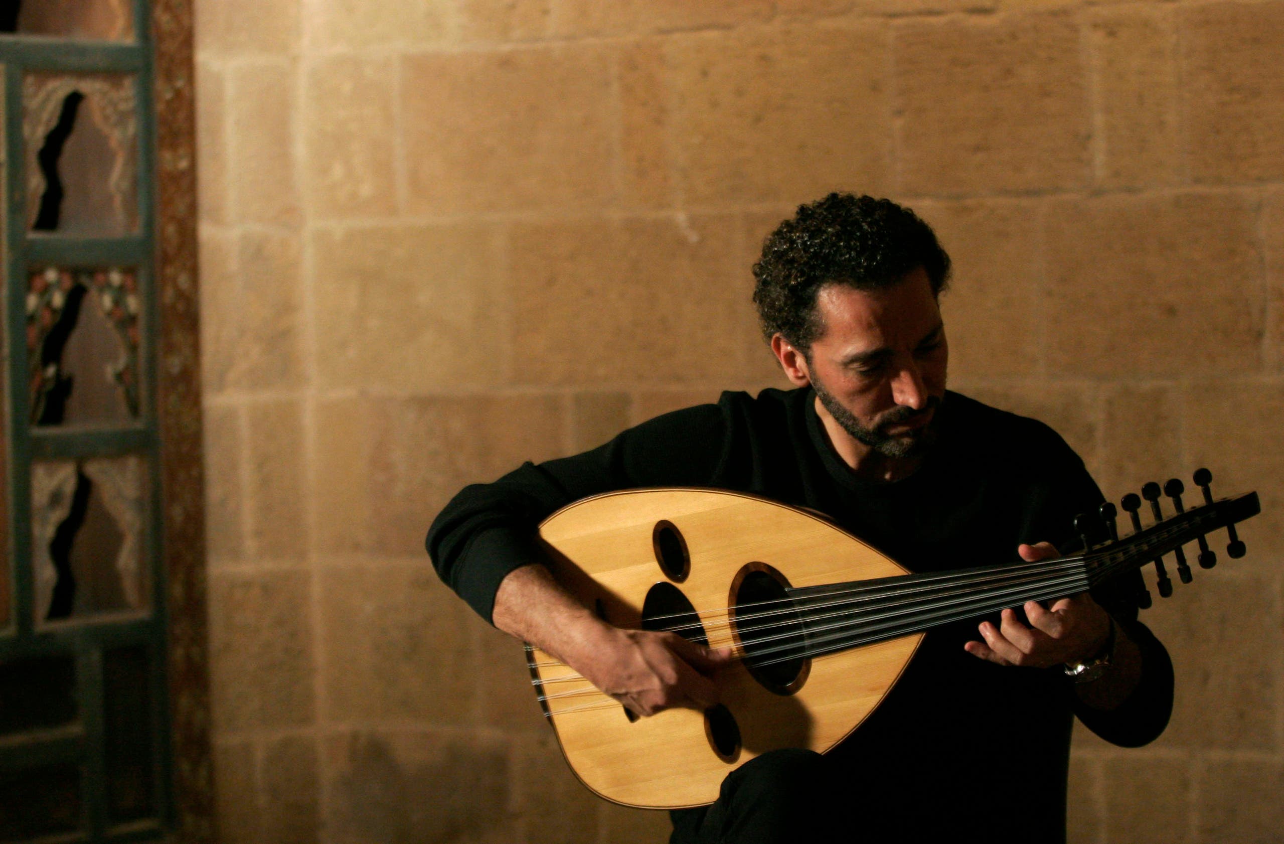 Prominent Iraqi musician Naseer Shamma plays the lute, or oud in Arabic, at the Arab Centre for Oud which he founded at a house built in the 14th century in Cairo this picture taken October 22, 2007. (Reuters)