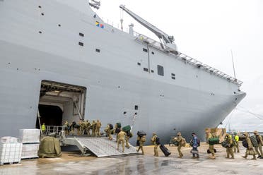 Members of the Australian Defense Force embark on HMAS Adelaide at the Port of Brisbane before departure to Tonga, in Brisbane, Australia, January 20, 2022. (Reuters)