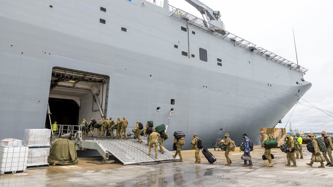 Members of the Australian Defense Force embark on HMAS Adelaide at the Port of Brisbane before departure to Tonga, in Brisbane, Australia, January 20, 2022. (Reuters)
