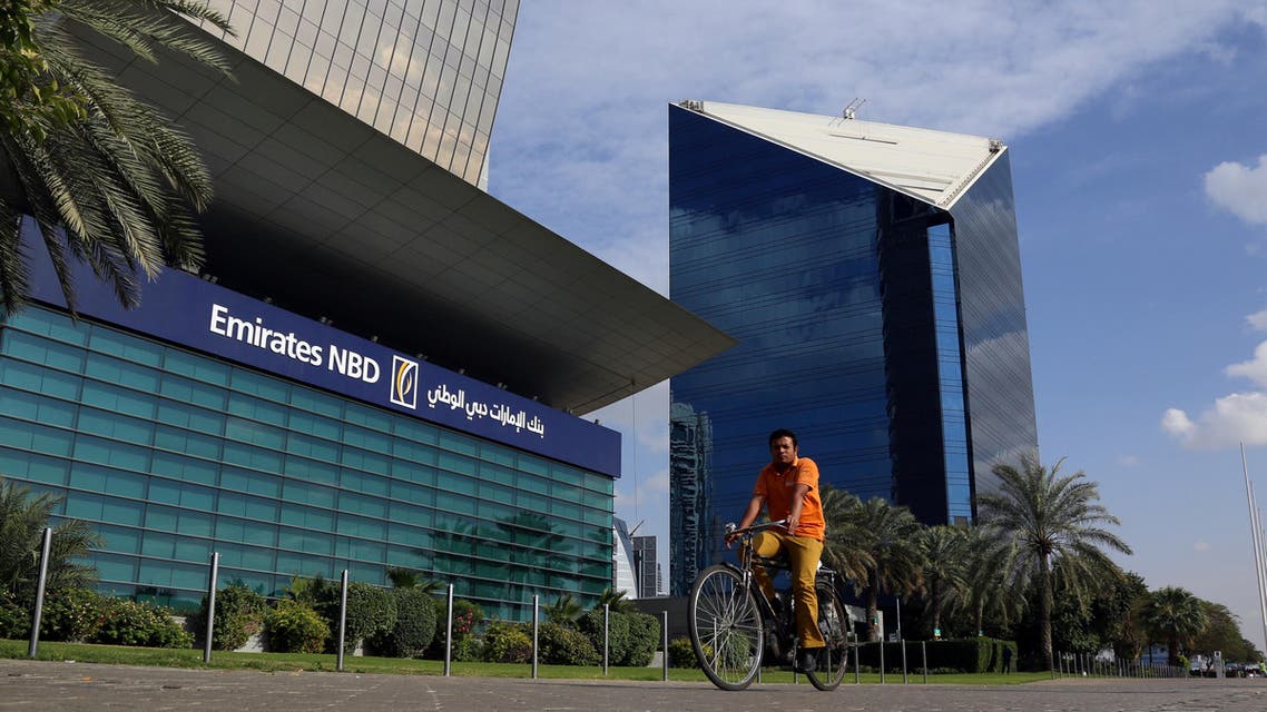A man rides a bicycle past Emirates NBD head office in Dubai, UAE January 30, 2018. REUTERS/Satish Kumar