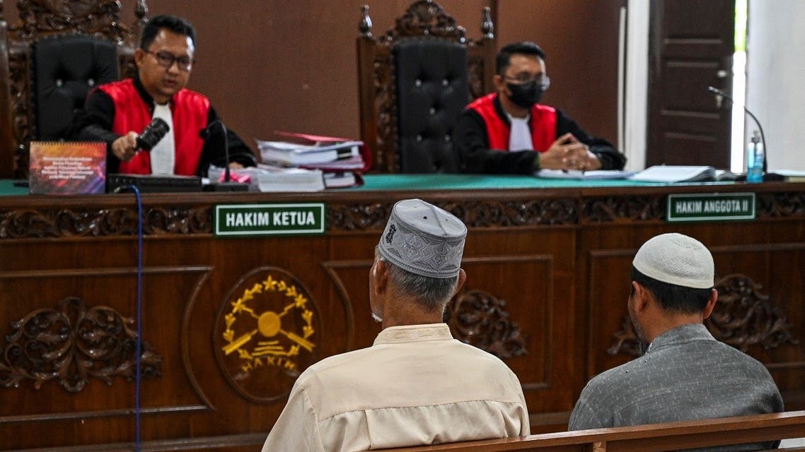 Two of the accused face the court before being sent to prison in Calang, Aceh province on January 27, 2022, after being found guilty of the 2020 killing of five critically endangered Sumatran elephants by electrocution and then peddling their lucrative tusks. (AFP)