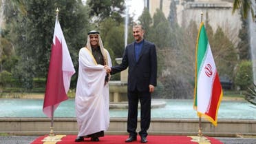 This handout picture provided by the Iranian foreign ministry on January 27, 2022, shows Iran's Foreign Minister Hossein Amir Abdollahian (R) welcoming Qatar's Deputy Prime Minister and Foreign Minister Mohammed bin Abdulrahman al- Thani, in the capital Tehran. (Photo by HO / Iranian Foreign Ministry / AFP)