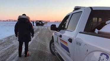 RCMP officers search the area where a family of four froze to death after crossing the border from the U.S. near Emerson, Manitoba, Canada, in this January 19, 2022 handout photo. (Reuters)