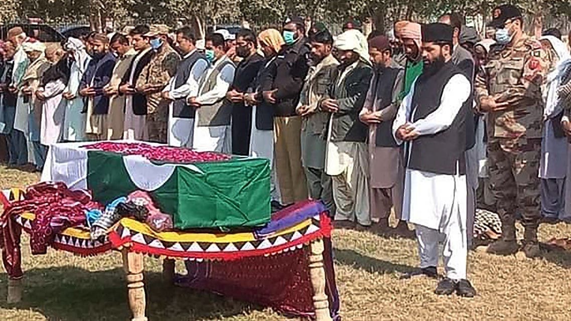 In this picture taken on January 27, 2022, military officials and local residents offer funeral prayers for a soldier who was killed in an attack in the Kech district of Balochistan province, in Dera Murad Jamali. (AFP)