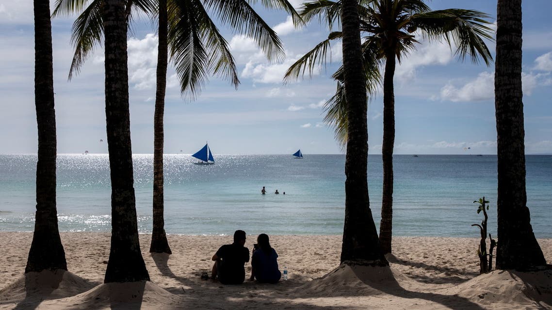 A couple enjoys a view of White Beach amid the coronavirus disease (COVID-19) outbreak, in Boracay Island, Aklan province, Philippines, November 29, 2021. (Reuters)