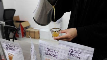 Lateefa al-Waalan, a Saudi woman who founded the Yatooq company and developed a machine to produce Arabic coffee, pours coffee in a cup at her factory in the capital Riyadh on December 11, 2014. (AFP)