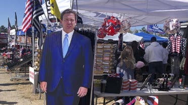 A cardboard cutout of Florida Gov. Ron DeSantis stands in the merchandise area outside former President Donald Trump's rally in Conroe, Texas, on, January 29, 2022. (AP)