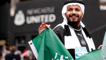 Soccer Football - Premier League - Newcastle United v Chelsea - St James' Park, Newcastle, Britain - October 30, 2021 Newcastle United fan with a Saudi Arabia flag wears Arab style clothing outside the stadium before the match Action Images via Reuters/Lee Smith EDITORIAL USE ONLY. No use with unauthorized audio, video, data, fixture lists, club/league logos or 'live' services. Online in-match use limited to 75 images, no video emulation. No use in betting, games or single club /league/player publications. Please contact your account representative for further details.