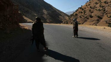 A member of the Kurdistan Workers' Party (PKK) carries an automatic rifle on a road in the Qandil Mountains, the PKK headquarters in northern Iraq, on June 22, 2018. (AFP)