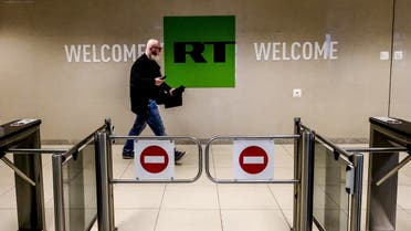 This file photo taken on June 08, 2018 shows a man as he walks past a control post of the Russia Today (RT) TV company in Moscow. The German broadcasting regulator said on February 2, 2022 it had banned the transmission of the German-language channel of Russian state broadcaster RT, amid rising tensions between Moscow and the West. (Photo by Yuri KADOBNOV / AFP) 