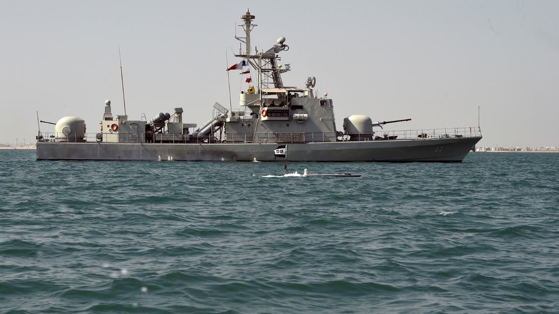 A Man-Portable Tactical Autonomous Systems (MANTAS) T-12 unmanned surface vessel (USV) sails alongside Royal Bahrain Naval Force (RBNF) Abdulrahman Al Fadhel in the Gulf waters during a joint naval exercise between US 5th Fleet Command and Bahraini forces, on October 26, 2021. (AFP)