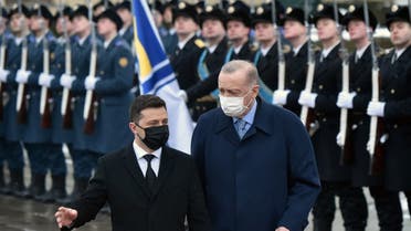 Ukraine's President Volodymyr Zelensky (L) and his Turkish counterpart Recep Tayyip Erdogan (C) review an honour guard during a welcoming ceremony prior to their talks in Kyiv on February 3, 2022. Erdogan will attempt to mediate between his Ukrainian ally and Russia in Kiev on February 3, 2022, adding his voice to the intense European efforts to avoid an armed conflict. (AFP)
