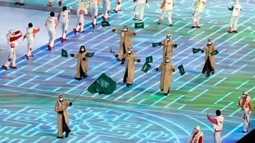 Flag bearer Fayik Abdi of Saudi Arabia during the athletes parade at the opening ceremony of the winter games in Beijing, China on February 4, 2022. (Reuters)