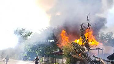This handout taken on September 10, 2021 and received courtesy of an anonymous source on September 18 shows people attempting to extinguish a fire as houses burn in Namg Kar village in Magwe region's Gangaw township, as fighting continues between the Myanmar military and protesters against the military coup. (File photo: AFP)
