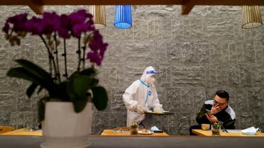 A waiter wears personal protective equipment (PPE) while on duty at a hotel for journalists and officials inside the Thaiwoo Ski Resort ahead of the Beijing 2022 Winter Olympics, in Zhangjiakou, China, January 31, 2022. (File photo: Reuters)