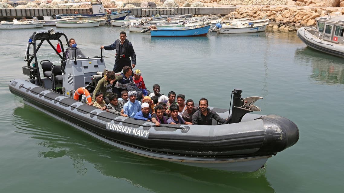 Migrants rescued by Tunisia’s national guard during an attempted crossing of the Mediterranean by boat arrive at the port of el-Ketef in Ben Guerdane in southern Tunisia near the border with Libya on June 27, 2021. (AFP)