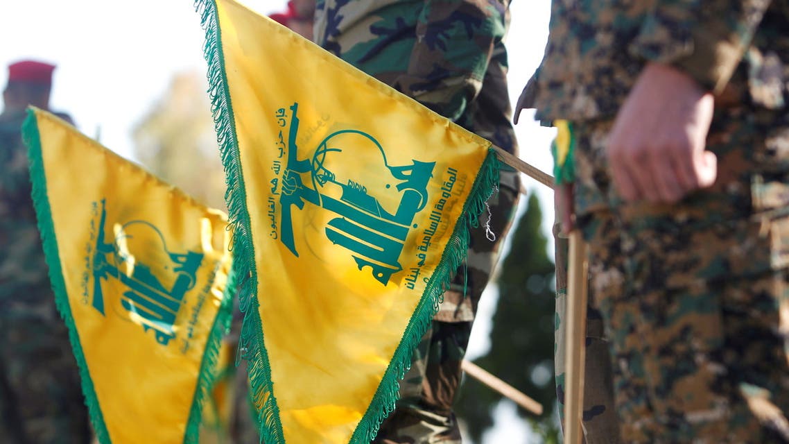 FILE PHOTO: Hezbollah members hold flags marking Resistance and Liberation Day, in Kfar Kila near the border with Israel, southern Lebanon, May 25, 2021. REUTERS/Aziz Taher/File Photo
