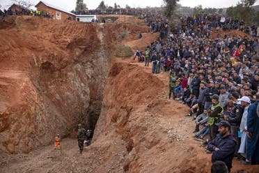 Bystanders watch as Moroccan emergency teams work to rescue five-year-old boy Rayan from a well shaft he fell into on February 1, in the remote village of Ighrane in the rural northern province of Chefchaouen on February 4, 2022. (AFP)