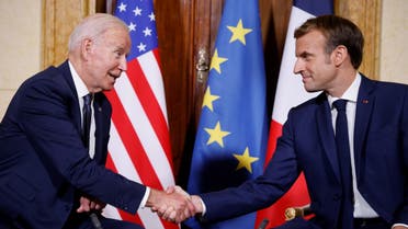 French President Emmanuel Macron (R) and US President Joe Biden (L) shake hands during their meeting at the French Embassy to the Vatican in Rome on October 29, 2021. (AFP)