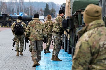US soldiers are seen next to their vehicles outside the G2A Arena after arriving at Rzeszow-Jasionka Airport in Jasionka, Poland on February 6, 2022. (Reuters)