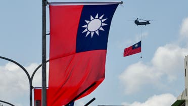 A CH-47 Chinook helicopter carries a Taiwan flag during national day celebrations in Taipei on October 10, 2021. (Photo by Sam Yeh  AFP)