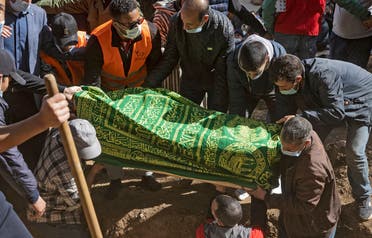 Moroccans bury five-year-old Rayan Oram in the village of Ighrane in Morocco's rural northern province of Chefchaouen, on February 7, 2022. (AFP)