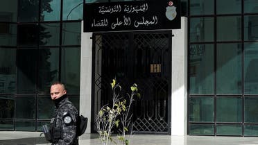 A police officer walks outside the Supreme Judicial Council building during a protest in Tunis, Tunisia, on February 6, 2022. (Reuters)