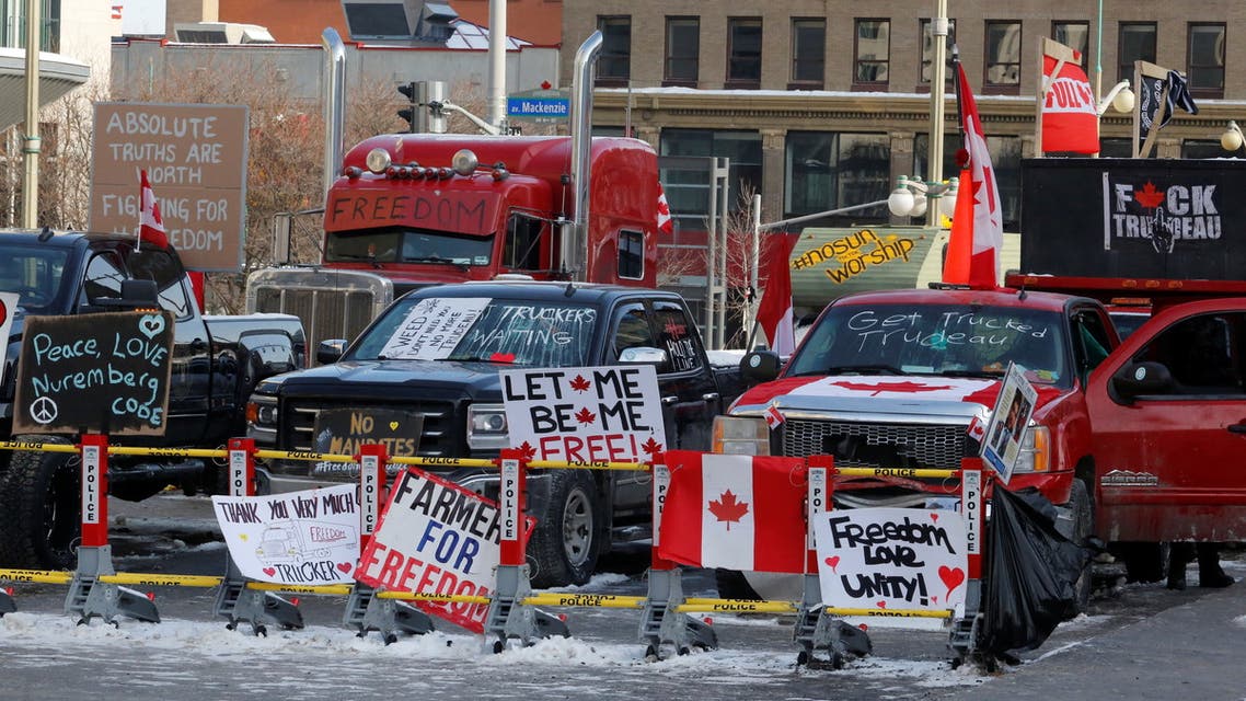 Signs sit on a police baracade as truckers and their supporters continue to protest coronavirus disease (COVID-19) vaccine mandates, in Ottawa, Ontario, Canada, February 7, 2022. REUTERS/Patrick Doyle