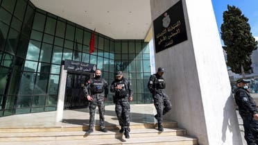 Members of the Tunisian security forces stand outside the closed entrance to the headquarters of Tunisia's Supreme Judicial Council (CSM) in the capital Tunis on February 6, 2022. (AFP)