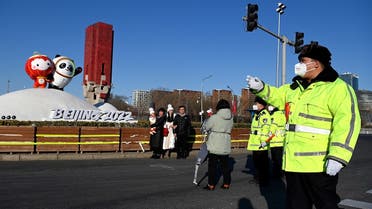 Policemen ask people to clear the area in front of Dwen (R) and Shuey Rhon Rhon, respective mascots of the 2022 Beijing Winter Olympic and Paralympic Games, hours before the opening ceremony, Beijing, February 4, 2022. (AFP)