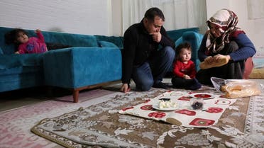Esat Celik, a 32-year-old construction worker, eats breakfast with his wife Cigdem and children at their home in Istanbul, Turkey February 8, 2022. (Reuters)