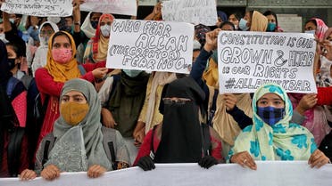 Muslim students display placards during a protest against the recent hijab ban in few colleges of Karnataka state, at Aliah University in Kolkata, India, February 9, 2022. (Reuters)