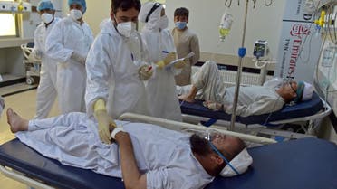 In this photograph taken on June 8, 2021, medical personnel treat Covid-19 coronavirus patients at the intensive care unit (ICU) of the Muhammed Ali Jinnah hospital in Kabul. (AFP)