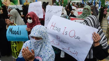 Supporters of Islamic political party Jamaat-e-Islami (JI) hold placards during a protest against the recent hijab ban in few educational institutes of Karnataka state, in Karachi on February 10, 2022. (AFP)                  