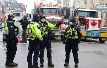 Police members patrol a downtown area where trucks are blocking roads as truckers and their supporters continue to protest against the coronavirus disease (COVID-19) vaccine mandates, in Ottawa, Ontario, Canada, February 8, 2022. (Reuters)